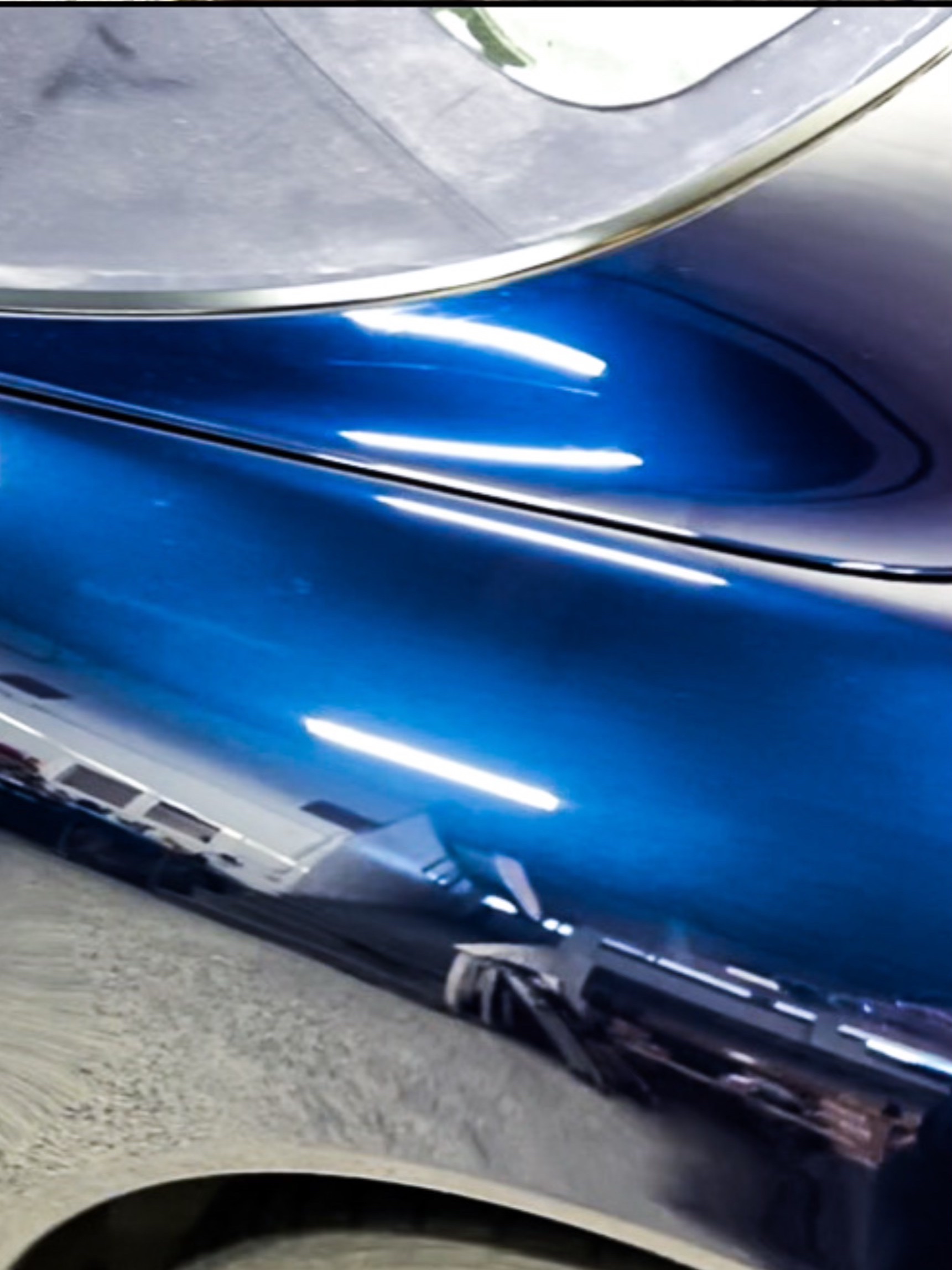 Blue Porsche lower body paint-reflection detail